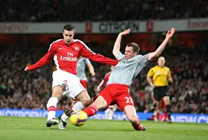 Robin van Persie shoots past Jamie Carragher to score