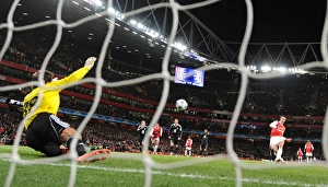 Arsenal v Partizan Belgrade 2010-11 Collection: Robin van Persie shoots past Partizan goalkeeper Vladimir Stojkovic to score the 1st Arsenal goal