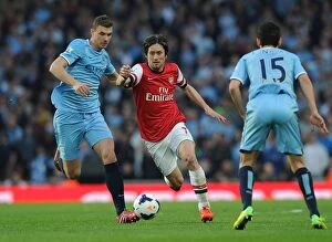 Images Dated 29th March 2014: Rosicky's Magic: Outsmarting Dzeko and Navas in the Thrilling 2013/14 Arsenal vs