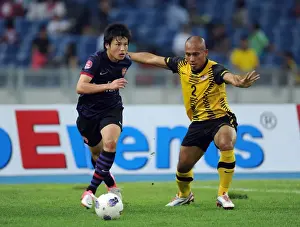 Malaysia XI V Arsenal 2012-13 Prints: Ryo Miyaichi vs Mahalli Bin Jasuli: A Clash in the Malaysia XI vs Arsenal Friendly, 2012