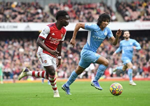Arsenal v Manchester City 2021-22 Collection: Saka Scores Spectacular Goal: Arsenal's Star Outwits Manchester City's Ake in Epic Premier League