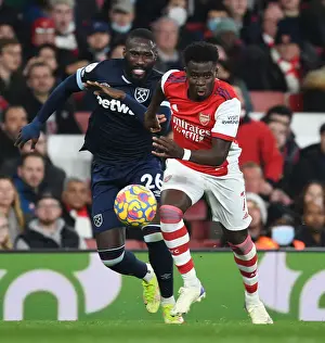 Arsenal V West Ham United 2021-22 Prints: Saka Slices Through Masuaku: Arsenal's Star Outmaneuvers West Ham Defender in Premier League Clash