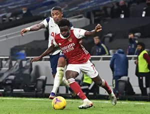 Saka Stands Strong: Bukayo Faces Off Against Bergwijn and Aurier in Intense Arsenal-Tottenham Showdown, 2020-21 Premier League