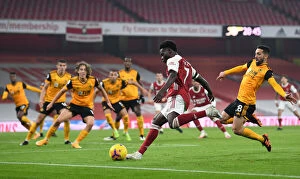 Arsenal v Wolverhampton Wanderers 2020-21 Collection: Saka vs. Moutinho: A Premier League Showdown at Emirates Stadium - Arsenal vs