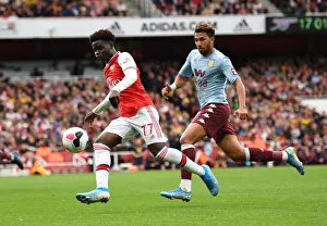 Saka vs. Trezeguet: A Premier League Showdown - Intense Face-Off Between Arsenal's Young Gun and Aston Villa's Midfielder