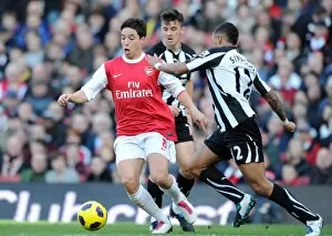 Arsenal v Newcastle United 2010-11 Collection: Samir Nasri (Arsenal) Danny Simpson (Newcastle). Arsenal 0: 1 Newcastle United
