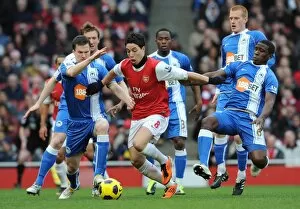 Arsenal v Wigan Athletic 2010-11 Collection: Samir Nasri (Arsenal) Gary Caldwell and Hendry Thomas (Wigan). Arsenal 3: 0 Wigan Athletic