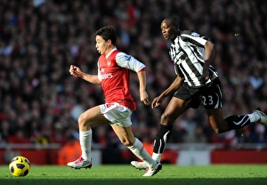 Arsenal v Newcastle United 2010-11 Collection: Samir Nasri (Arsenal) Shola Ameobi (Newcastle). Arsenal 0: 1 Newcastle United