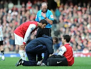 Images Dated 7th November 2010: Samir Nasri (Arsenal) is treated by physio Colin Lewin as Cesc Fabregas