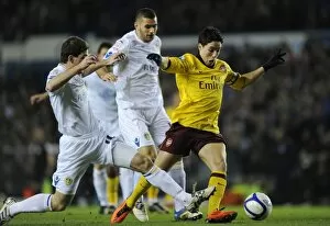 Images Dated 19th January 2011: Samir Nasri breaks past Leeds defender Ben Parker to score the 1st Arsenal goal
