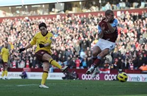Aston Villa v Arsenal 2010-11 Gallery: Samir Nasri scores Arsenals 2nd goal under pressure from Luke Young (Villa)