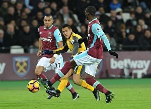 Images Dated 3rd December 2016: Sanchez Evades Obiang: Intense Moment from West Ham vs. Arsenal Premier League Clash