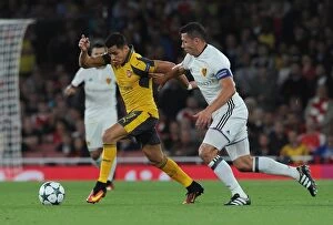 Arsenal v FC Basel 2016-17 Collection: Sanchez vs. Suchy: A Champions League Showdown - Intense Face-Off Between Arsenal's Sanchez