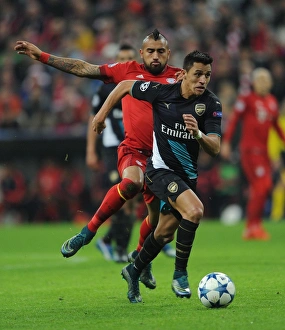 Bayern Munich V Arsenal 2015-16 Prints: Sanchez vs. Vidal: A Champions League Showdown - Arsenal's Star Forward Clashes with Bayern's Midfield Maestro
