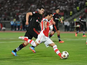 Besiktas V Arsenal 2014-15 Prints: Santi Cazorla Faces Off Against Pedro Franco: Tense Moment from Arsenal's UEFA Champions League Clash with Besiktas