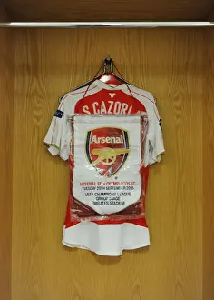 Arsenal V Olympiacos 2015/16 Prints: Santi Cazorla's Arsenal FC Changing Room: Shirt and Match Pennant (Arsenal vs)
