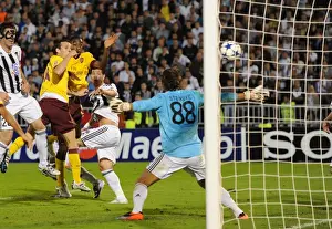 Sebastien Squillaci heads past Partizan goalkeeper Vladimir Stojkovic to score the 3rd Arsenal goal