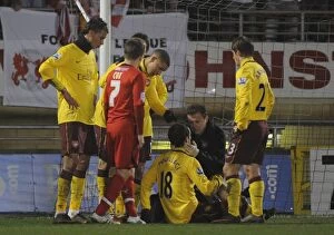 Leyton Orient v Arsenal - FA Cup 2010-2011 Collection: Sebastien Squillaci is treated by Arsenal physio Colin Lewin. Leyton Orient 1: 1 Arsenal