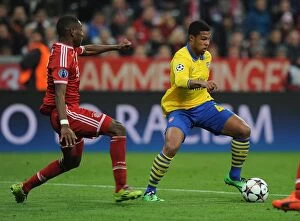 Images Dated 11th March 2014: Serge Gnabry vs. David Alaba: Battle at the Allianz Arena - Arsenal vs