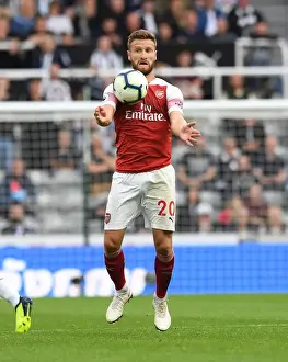 Newcastle United V Arsenal 2018-19 Prints: Shkodran Mustafi's Unwavering Concentration in the Heat of Newcastle United vs Arsenal FC Clash (2018-19)