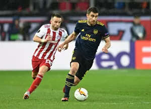 Images Dated 20th February 2020: Sokratis Clashes with Valbuena: Olympiacos vs. Arsenal, UEFA Europa League 2019-20 Round of 32