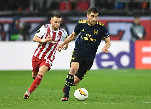 Olympiacos V Arsenal 2019-20 Prints: Sokratis Clashes with Valbuena: Olympiacos vs