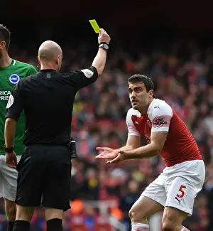 Sokratis Shown Yellow Card by Referee Taylor in Arsenal vs. Brighton Match