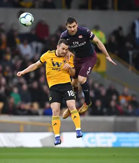 Wolverhampton Wanderers V Arsenal 2018-19 Prints: Sokratis vs. Diogo Jota: Intense Heading Battle at Wolverhampton Wanderers vs