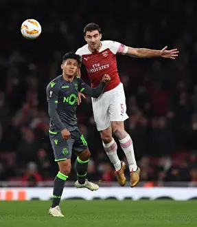 Arsenal V Sporting Clube De Portugal 2018-19 Prints: Sokratis vs Montero: A Head-to-Head Battle in Arsenal's Europa League Clash with Sporting CP