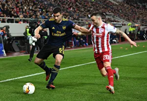 Olympiacos V Arsenal 2019-20 Prints: Sokratis vs Valbuena: Olympiacos vs Arsenal, UEFA Europa League Round of 32 First Leg