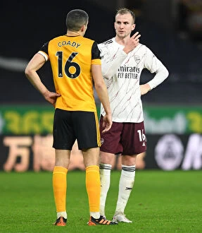 Wolverhampton Wanderers v Arsenal 2020-21 Collection: Sportsmanship in Rivalry: Holding and Coady's Heartfelt Moment after Wolverhampton vs Arsenal