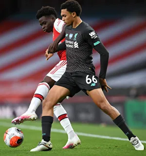Empty Stadium Showdown: Bukayo Saka vs. Trent Alexander-Arnold - Arsenal vs. Liverpool, 2019-2020: A Riveting Rivalry Amidst an Empty Emirates Stadium