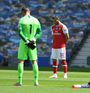 Brighton And Hove Albion V Arsenal 2019-20 Prints: Empty Stands: Sead Kolasinac Honors Silence at Brighton vs. Arsenal (2019-20)