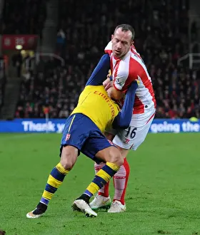 STOKE ON TRENT, ENGLAND - DECEMBER 06: Alexis Sanchez of Arsenal is fouled by Charlie