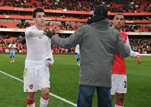 Suspended Emmanuel Eboue congratulates Cesc Fabregas and Gael Clichy after the match