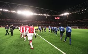 The teams walk out onto the pitch before the match