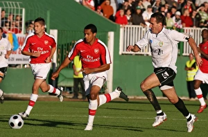 Szombathely v Arsenal 2008-09 Collection: Theo Walcott (Arsenal) Balazs Molnar (Szombathely)