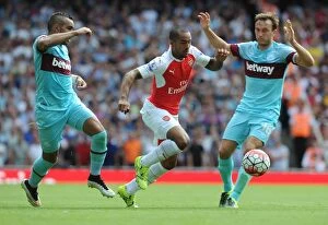 Images Dated 9th August 2015: Theo Walcott (Arsenal) Dimitri Payet and Mark Noble (West Ham). Arsenal 0: 2 West