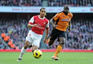 Images Dated 12th February 2011: Theo Walcott (Arsenal) George Elokobi (Wolves). Arsenal 2: 0 Wolverhampton Wanderers