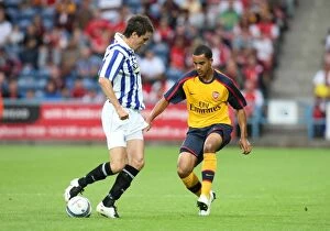 Huddersfield v Arsenal 2008-09 Collection: Theo Walcott (Arsenal) nutmegs Maichael Collins (Huddersfield)