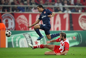 Images Dated 9th December 2009: Theo Walcott (Arsenal) Olof Mellberg (Olympiacos). Olympiacos 1: 0 Arsenal