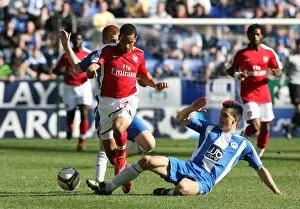 Images Dated 11th April 2009: Theo Walcott (Arsenal) Paul Scharner (Wigan)
