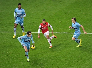 Images Dated 23rd January 2013: Theo Walcott (Arsenal) Ricardo Vaz te, Mark Noble and Joey O Brien (West Ham). Arsenal 5