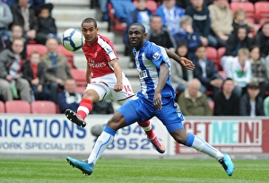 Images Dated 18th April 2010: Theo Walcott (Arsenal) Steve Gohouri (Wigan). Wigan Athletic 3: 2 Arsenal
