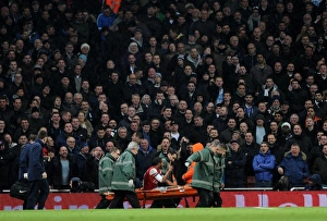 Arsenal v Tottenham Hotspur 2013-14 Collection: Theo Walcott (Arsenal) is stretchered from the pitch. Arsenal 2: 0 Tottenham Hotspur