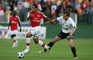 Szombathely v Arsenal 2008-09 Collection: Theo Walcott (Arsenal) Zsolt Kovacs (Szombathely)