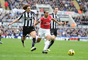 Theo Walcott breaks past Newcastle defender Fabricio Coloccini to score the 1st Arsenal goal Theo Walcott breaks past Newcastle defender Fabricio Coloccini to score the 1st Arsenal goal