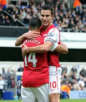 Images Dated 31st March 2012: Theo Walcott celebrates scoring Arsenals goal with Robin van Persie. Queens Park Rangers 2