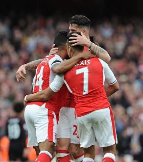Images Dated 2nd April 2017: Theo Walcott celebrates scoring a goal for Arsenal with Alexis Sanchez and Granit Xhaka