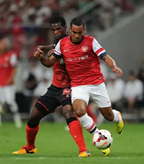 Nagoya Grampus V Arsenal 2013-14 Prints: Theo Walcott Fouls by Danilson during Nagoya Grampus vs Arsenal Match, 2013